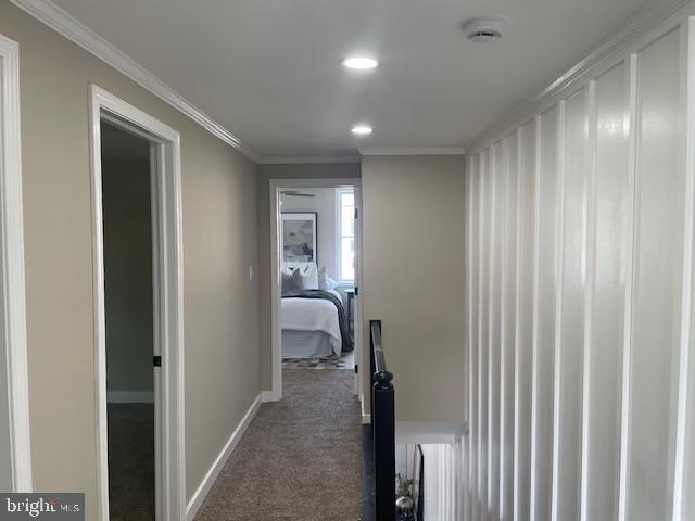 924 N Belnord Ave, Baltimore, MD 21205 - corridor featuring dark colored carpet, baseboards, ornamental molding, and recessed lighting