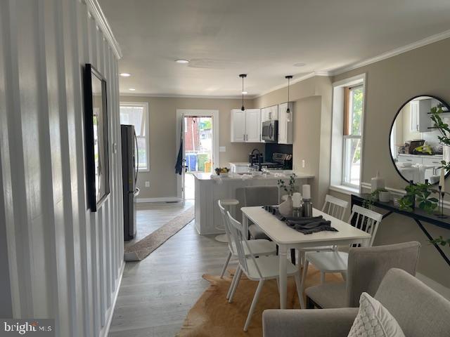 924 N Belnord Ave, Baltimore, MD 21205 - dining space featuring ornamental molding, light wood-type flooring, baseboards, and recessed lighting
