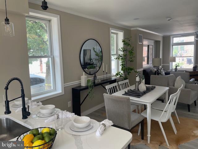924 N Belnord Ave, Baltimore, MD 21205 - dining space with crown molding and wood finished floors