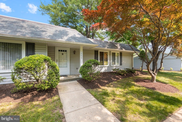 14627 Deerhurst Ter Unit 214-A, Silver Spring, MD 20906 - view of front facade with a porch, a front yard, and a shingled roof