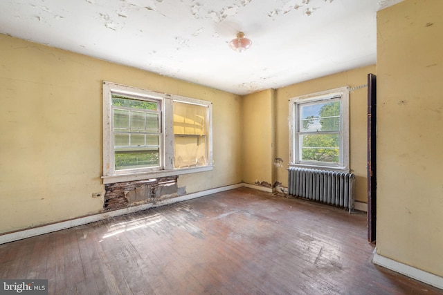 977 N 23rd St, Camden, NJ 08105 - unfurnished room with radiator heating unit and hardwood / wood-style floors