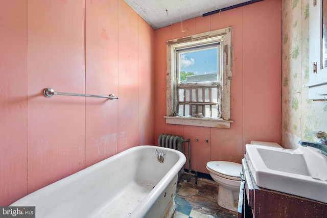 977 N 23rd St, Camden, NJ 08105 - full bath with radiator, a freestanding bath, and wood finished floors