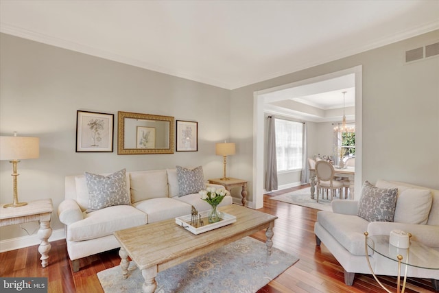 3930 Liz Cir, Doylestown, PA 18902 - living room featuring hardwood / wood-style flooring, crown molding, a chandelier, and a tray ceiling