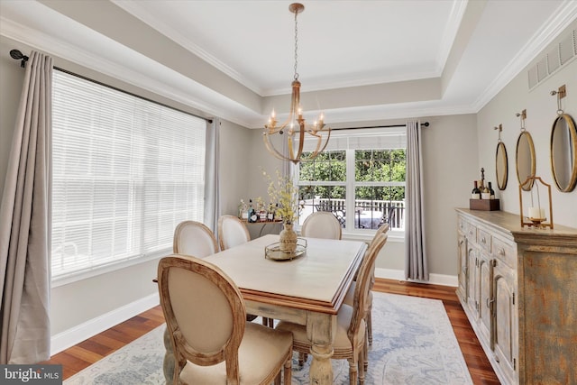 3930 Liz Cir, Doylestown, PA 18902 - dining room featuring a chandelier, dark wood-type flooring, a raised ceiling, and crown molding