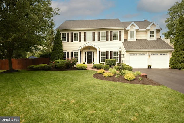 3930 Liz Cir, Doylestown, PA 18902 - colonial inspired home featuring concrete driveway, an attached garage, a chimney, and roof with shingles