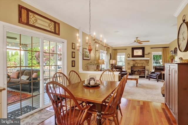 3930 Liz Cir, Doylestown, PA 18902 - dining room featuring a ceiling fan, a fireplace, light wood-style flooring, and crown molding
