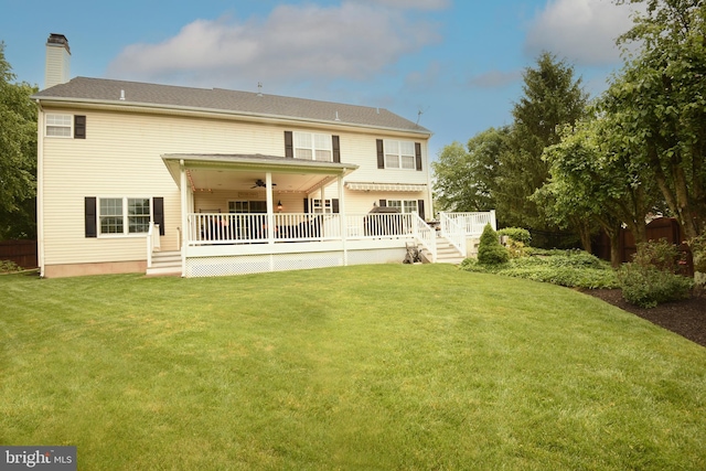 3930 Liz Cir, Doylestown, PA 18902 - back of house featuring a ceiling fan, a lawn, a chimney, and a deck