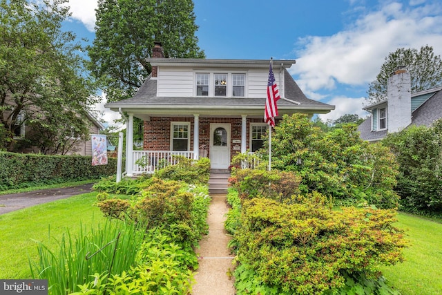 120 W Seventh St Unit 150, Media, PA 19063 - bungalow-style home with a porch, brick siding, a chimney, a front yard, and a shingled roof