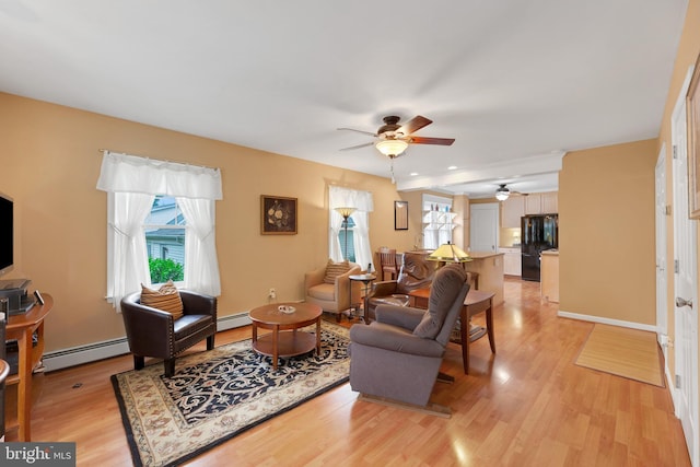 120 W Seventh St Unit 150, Media, PA 19063 - living room featuring a ceiling fan, baseboard heating, and light wood-style floors