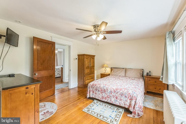 120 W Seventh St Unit 150, Media, PA 19063 - bedroom with radiator, light wood-type flooring, and a ceiling fan