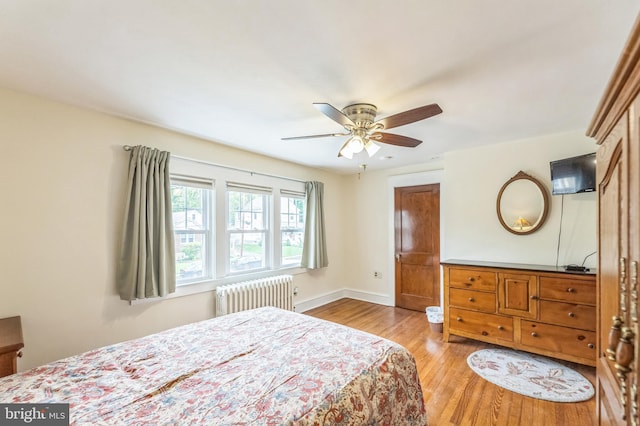120 W Seventh St Unit 150, Media, PA 19063 - bedroom with radiator heating unit, wood finished floors, and a ceiling fan