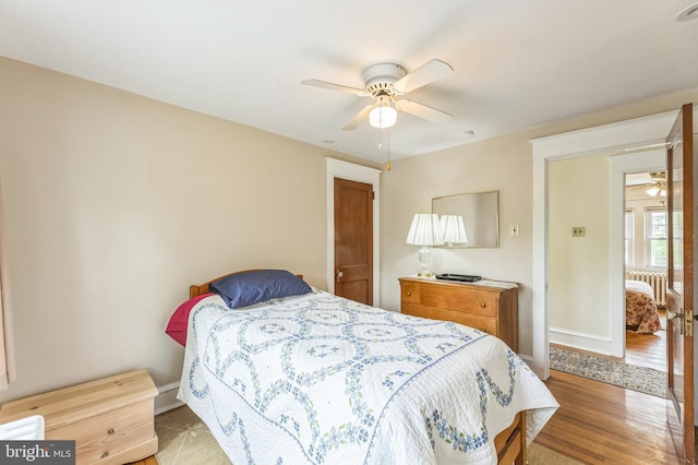 120 W Seventh St Unit 150, Media, PA 19063 - bedroom with wood finished floors, radiator, and ceiling fan