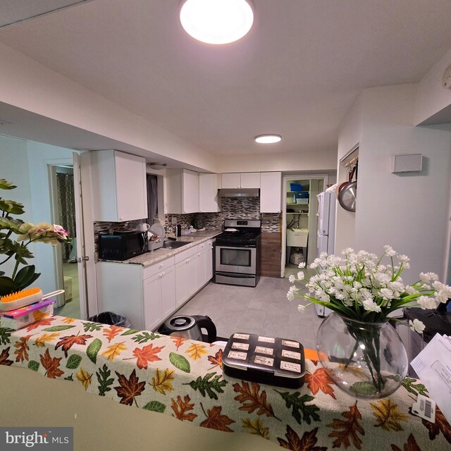 1709 Kingswood Pl, Clementon, NJ 08021 - kitchen with stainless steel range with gas cooktop, black microwave, white cabinetry, light countertops, and backsplash