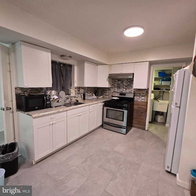 1709 Kingswood Pl, Clementon, NJ 08021 - kitchen featuring gas range, black microwave, freestanding refrigerator, under cabinet range hood, and white cabinetry