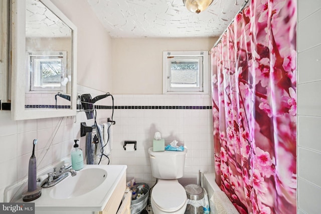 713 Washington St, Easton, PA 18042 - bathroom with plenty of natural light, tile walls, vanity, and shower / bathtub combination with curtain