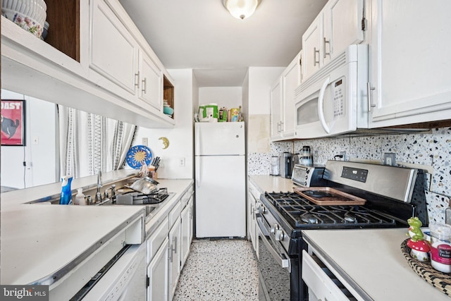 713 Washington St, Easton, PA 18042 - kitchen featuring white appliances, white cabinetry, light countertops, and decorative backsplash