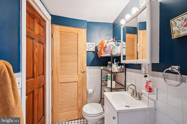 713 Washington St, Easton, PA 18042 - bathroom featuring vanity, a wainscoted wall, a closet, and tile walls