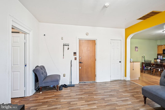 713 Washington St, Easton, PA 18042 - living area with light wood-style flooring and arched walkways