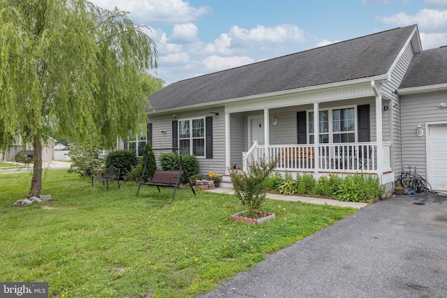 406 Gladys St, Ellendale, DE 19941 - ranch-style home featuring covered porch, a shingled roof, a front lawn, and a garage