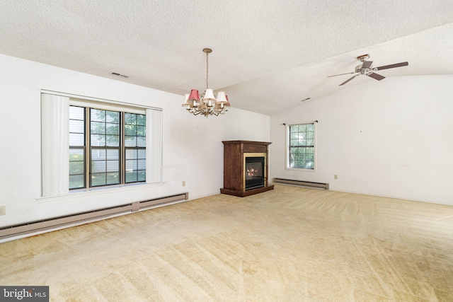 30 Hilltop Ln W, Columbus, NJ 08022 - unfurnished living room featuring healthy amount of natural light, baseboard heating, carpet, a textured ceiling, and vaulted ceiling