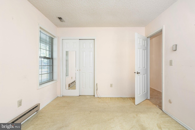30 Hilltop Ln W, Columbus, NJ 08022 - unfurnished bedroom featuring a baseboard radiator, carpet flooring, a textured ceiling, and a closet