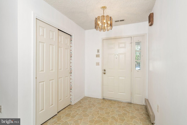 30 Hilltop Ln W, Columbus, NJ 08022 - entryway with a chandelier, a textured ceiling, and a baseboard radiator