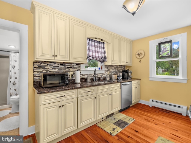 414 S Aurora St, Easton, MD 21601 - kitchen featuring stainless steel appliances, a baseboard heating unit, cream cabinetry, tasteful backsplash, and light wood-style floors