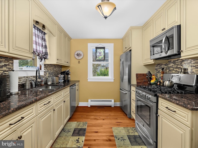 414 S Aurora St, Easton, MD 21601 - kitchen with stainless steel appliances, cream cabinets, a baseboard radiator, backsplash, and light wood finished floors