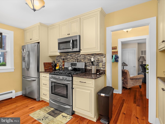 414 S Aurora St, Easton, MD 21601 - kitchen with appliances with stainless steel finishes, cream cabinets, tasteful backsplash, and light wood-style flooring