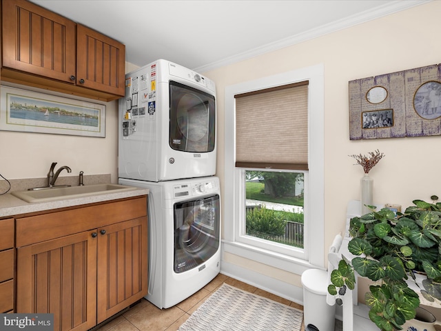 414 S Aurora St, Easton, MD 21601 - washroom with stacked washer and clothes dryer, light tile patterned flooring, and crown molding