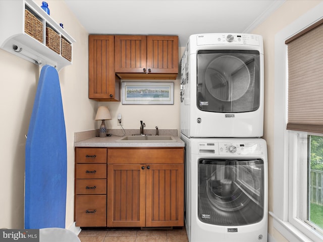 414 S Aurora St, Easton, MD 21601 - laundry area with estacked washer and dryer, cabinet space, and light tile patterned floors