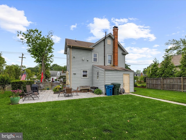 414 S Aurora St, Easton, MD 21601 - back of property with a patio and a chimney