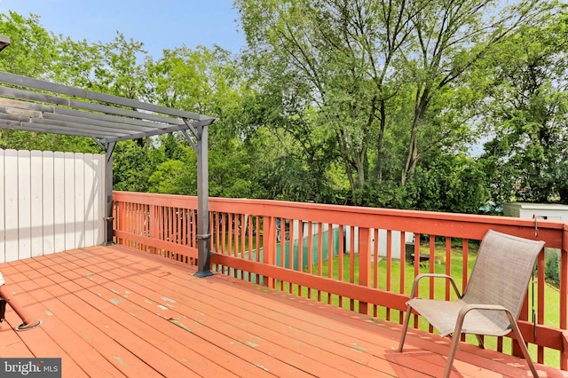 179 Dunlap Rd, Pasadena, MD 21122 - wooden deck with a pergola and view of scattered trees