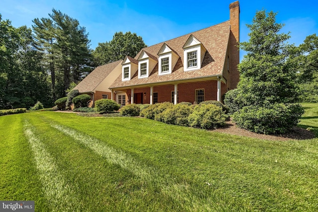 2647 Shepperd Rd, Monkton, MD 21111 - cape cod home featuring a chimney, a front yard, brick siding, and roof with shingles
