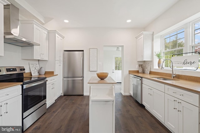 201 Parkway St, Winchester, VA 22601 - kitchen featuring stainless steel appliances, wall chimney range hood, a sink, white cabinets, and recessed lighting