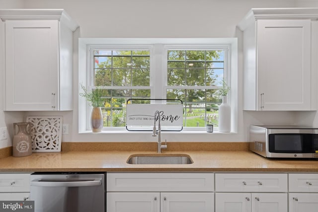 201 Parkway St, Winchester, VA 22601 - kitchen featuring appliances with stainless steel finishes, a sink, light countertops, and white cabinetry