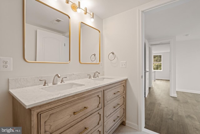 201 Parkway St, Winchester, VA 22601 - bathroom with double vanity, baseboards, and wood finished floors