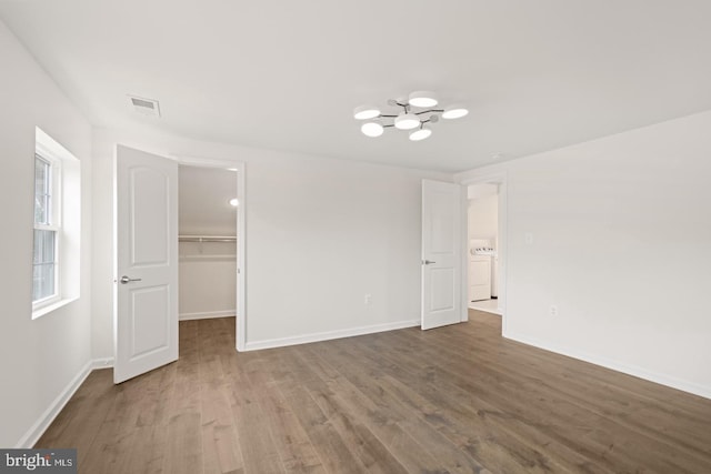 201 Parkway St, Winchester, VA 22601 - unfurnished bedroom featuring washer / clothes dryer, wood finished floors, a spacious closet, and baseboards