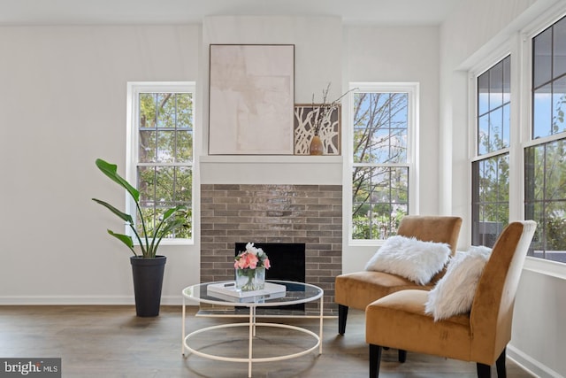 201 Parkway St, Winchester, VA 22601 - living area featuring wood finished floors, a brick fireplace, and baseboards