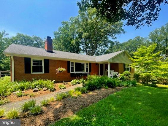 10704 Montgomery Dr, Manassas, VA 20111 - ranch-style home with a chimney and a front yard