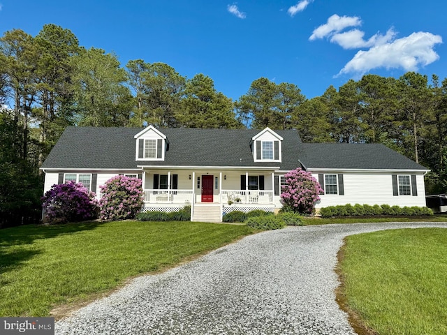 4 W Woodduck Dr, Tuckerton, NJ 08087 - new england style home featuring a porch, driveway, a front yard, and view of scattered trees