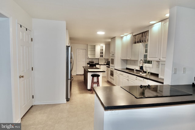 4 W Woodduck Dr, Tuckerton, NJ 08087 - kitchen featuring freestanding refrigerator, a sink, black electric stovetop, dark countertops, and recessed lighting