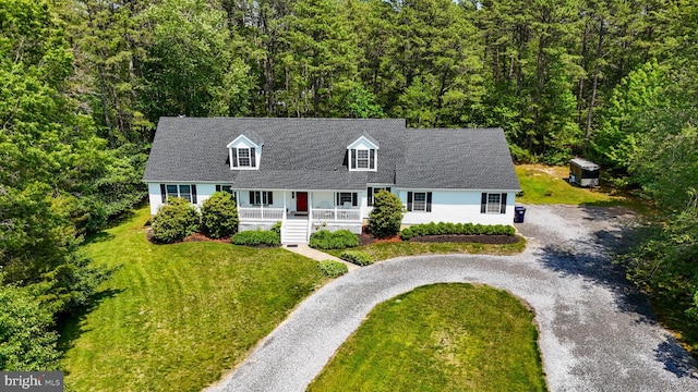 4 W Woodduck Dr, Tuckerton, NJ 08087 - cape cod-style house featuring a porch, driveway, a front yard, and a forest view