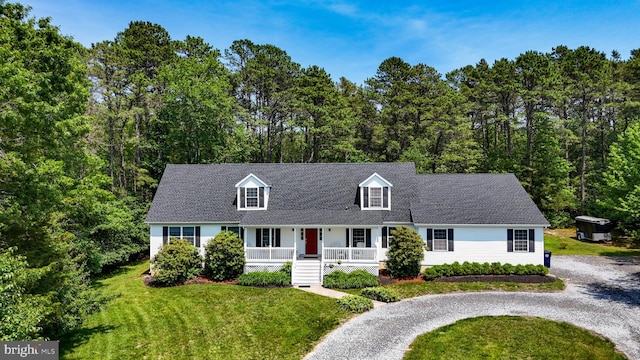 4 W Woodduck Dr, Tuckerton, NJ 08087 - new england style home with a porch, a front yard, and gravel driveway
