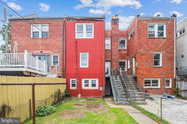 217 Jefferson St NW, Washington, DC 20011 - rear view of property with stairs, a fenced backyard, and brick siding