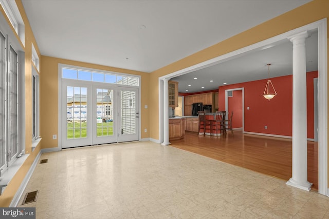 14014 Mary Bowie Pkwy, Upper Marlboro, MD 20774 - unfurnished living room featuring ornate columns, light flooring, and recessed lighting