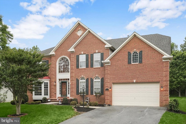 14014 Mary Bowie Pkwy, Upper Marlboro, MD 20774 - view of front of house with asphalt driveway, brick siding, an attached garage, a front yard, and a shingled roof