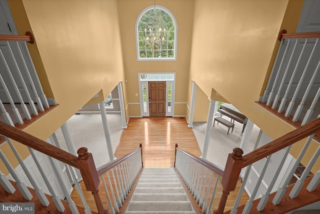 14014 Mary Bowie Pkwy, Upper Marlboro, MD 20774 - entryway with stairs, wood finished floors, a towering ceiling, and a chandelier