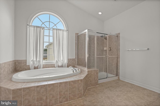 14014 Mary Bowie Pkwy, Upper Marlboro, MD 20774 - bathroom featuring a bath, a shower stall, tile patterned flooring, and vaulted ceiling