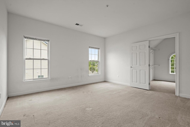 14014 Mary Bowie Pkwy, Upper Marlboro, MD 20774 - unfurnished bedroom featuring multiple windows, carpet flooring, and a walk in closet